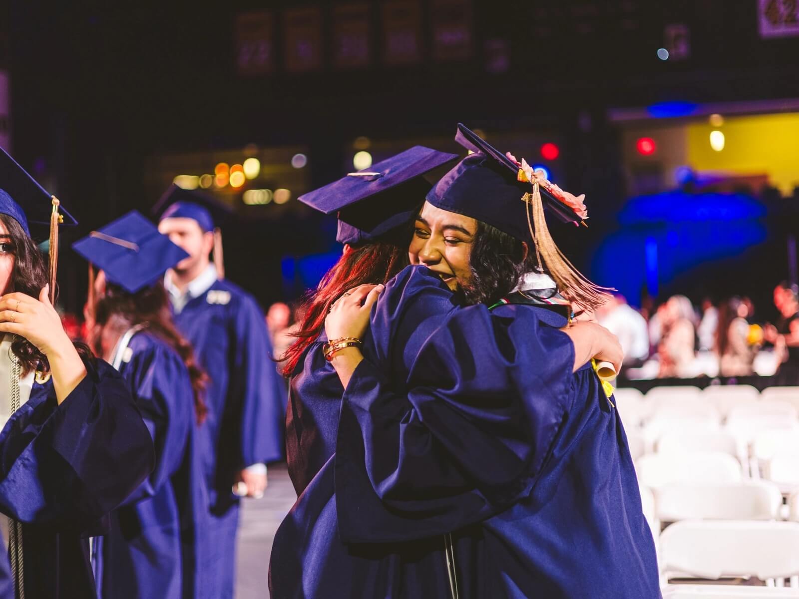 Two graduates hugging