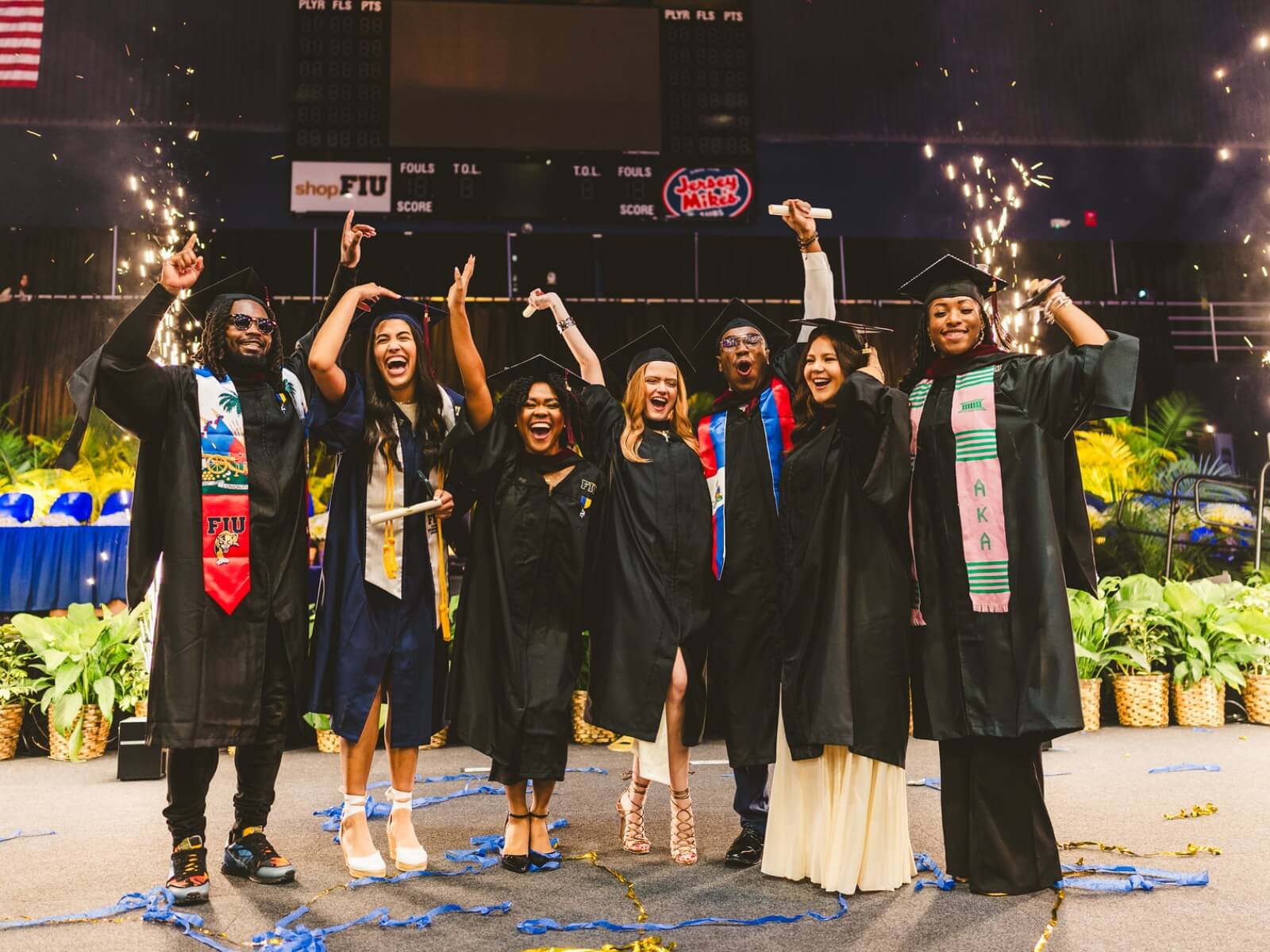 Graduates posing together on stage