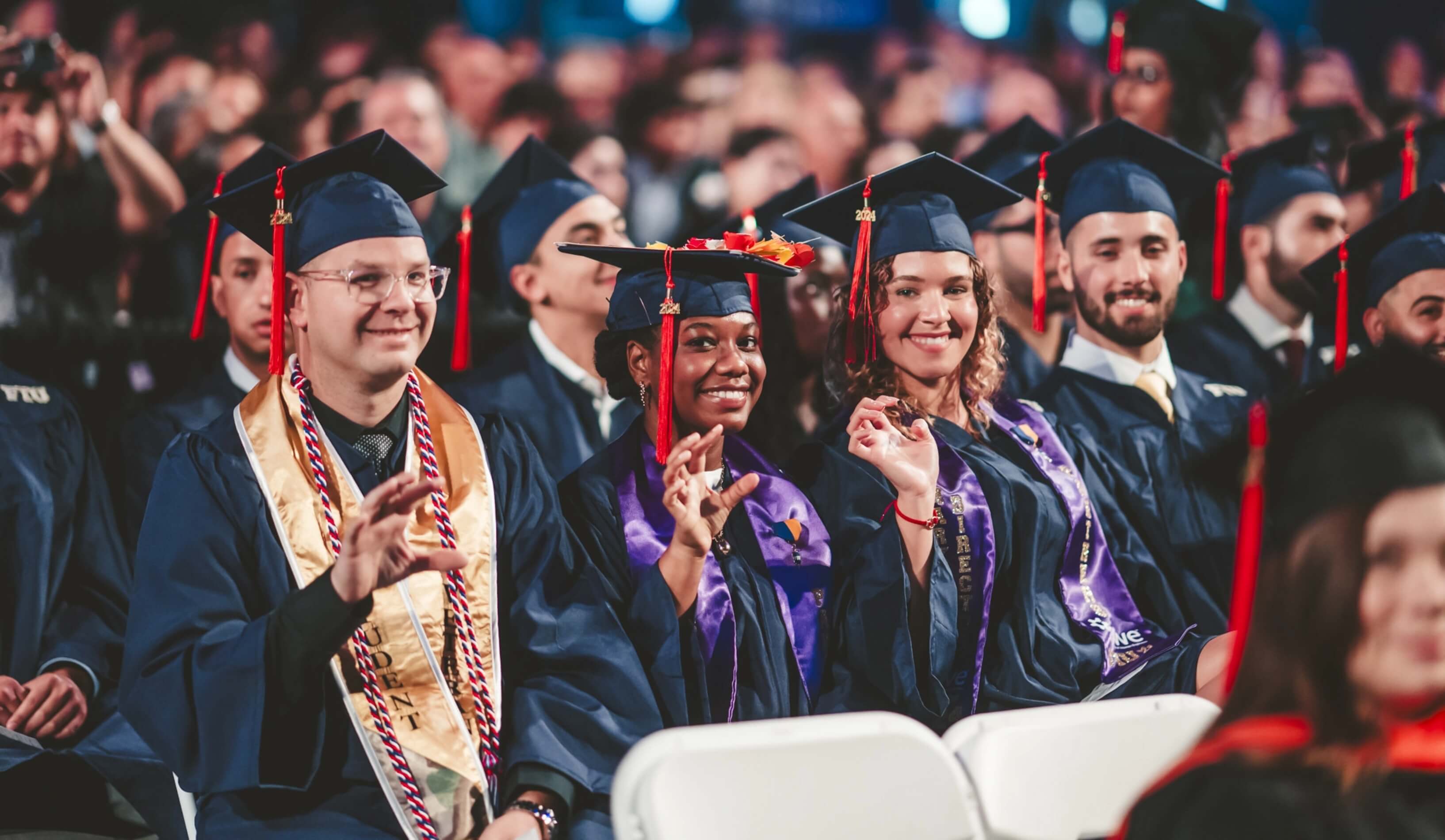 Graduates doing Paws Up gesture