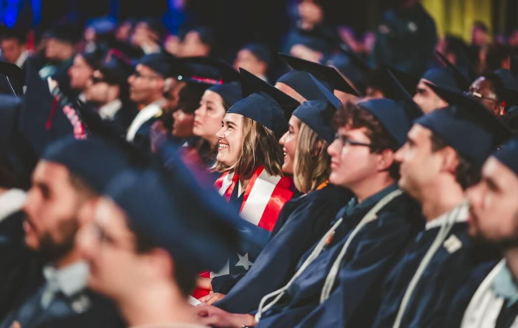 Graduate smiling in crowd