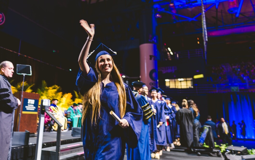 Graduate waving at audience