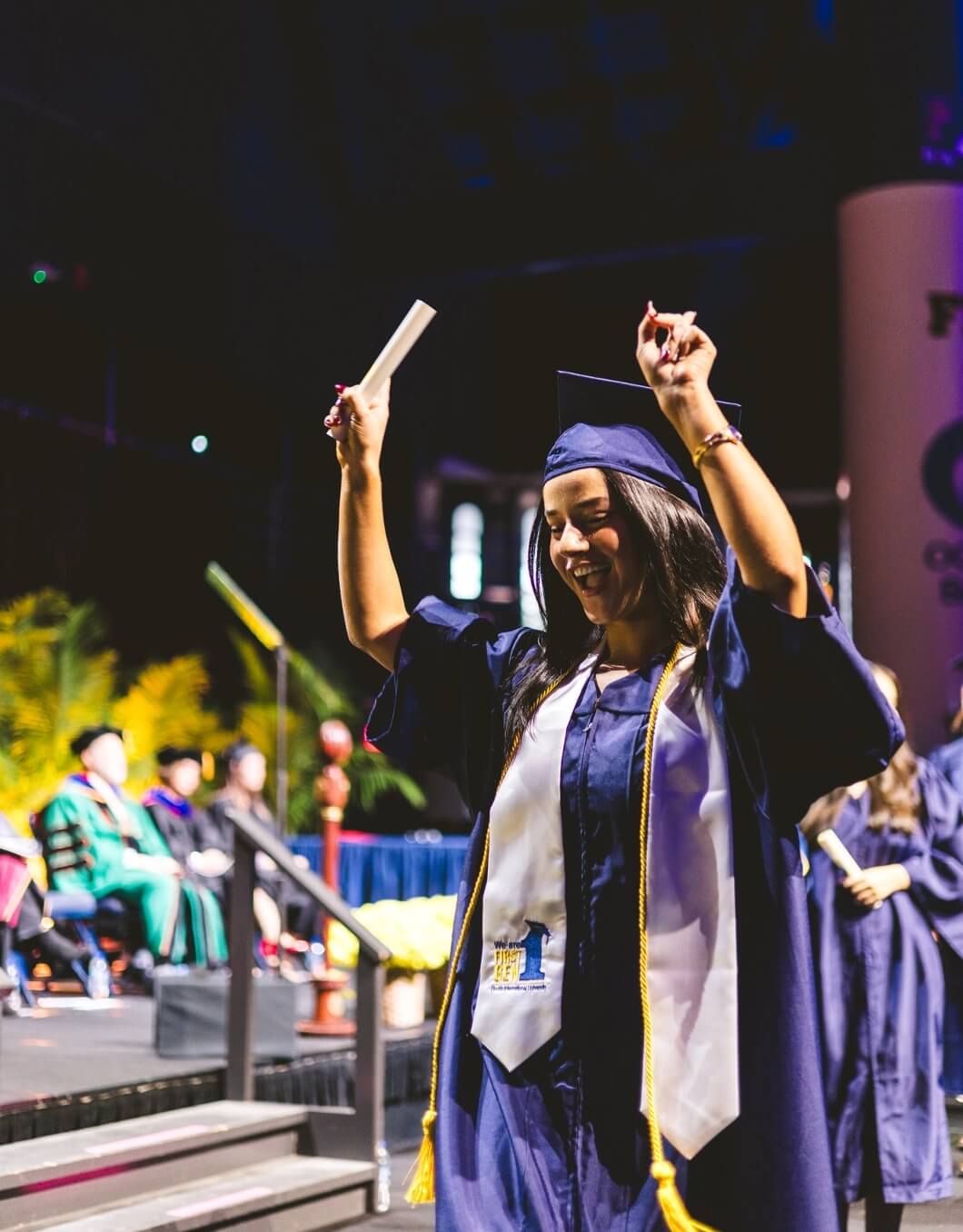 Graduate cheering on stage