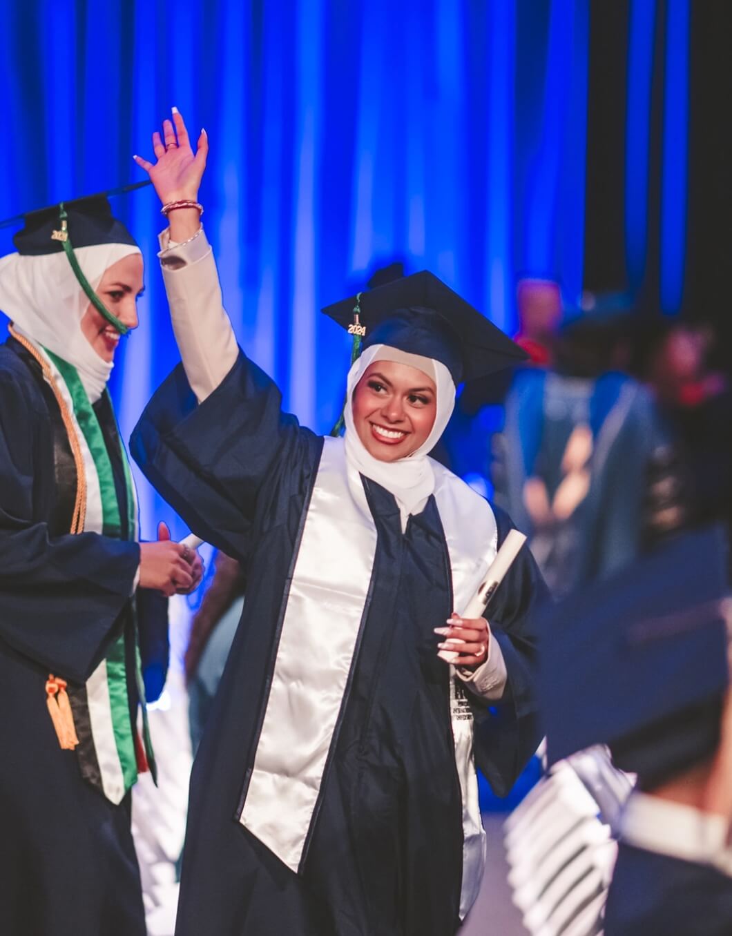 Graduate waving at audience