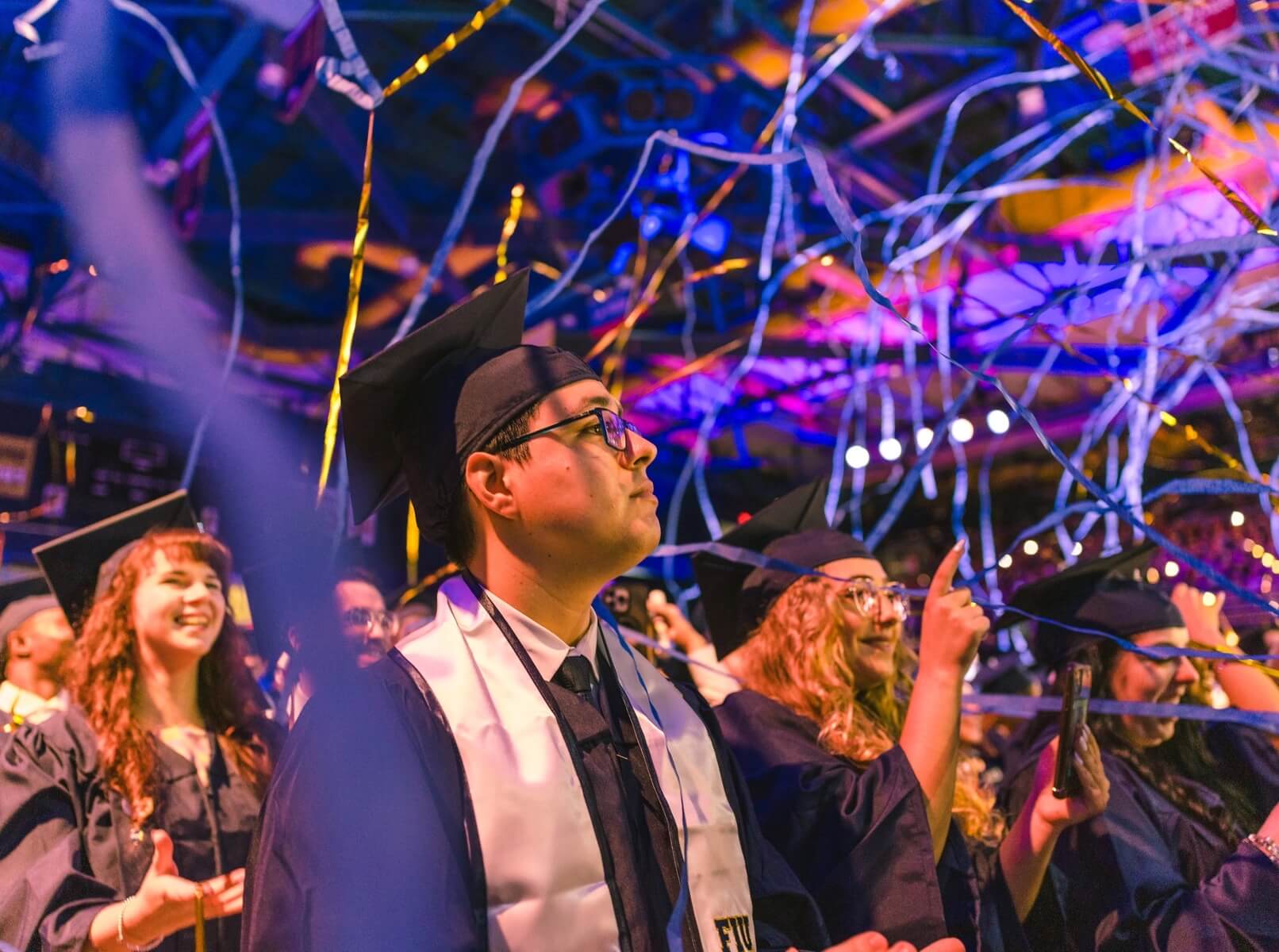 Graduate standing stoically as confetti falls