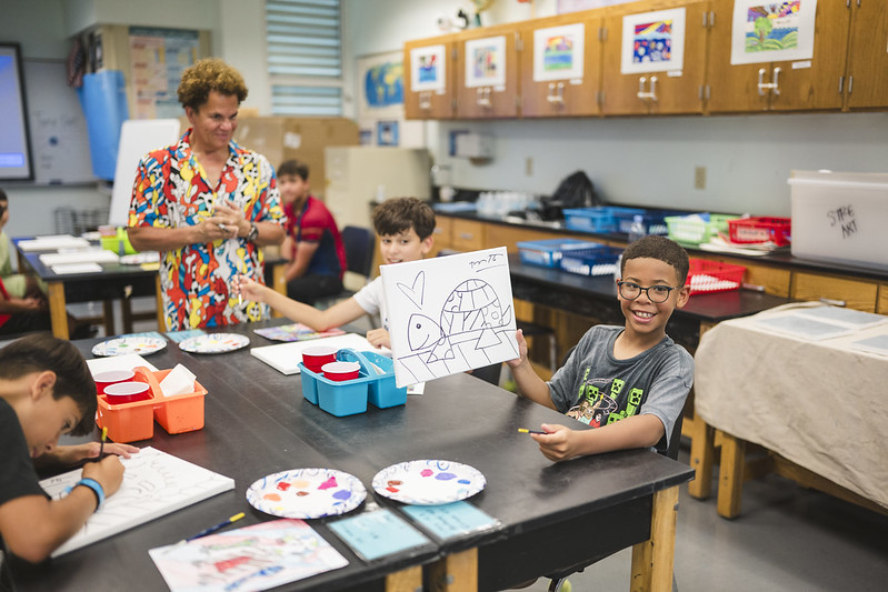 Camper showing off his custom art piece by Britto.