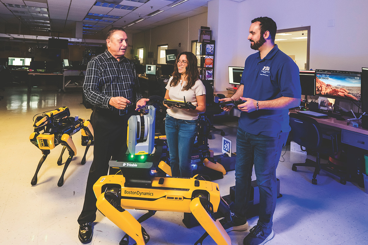 Leonel Lagos with students Maria Sotolongo and Carlos Rios in FIU’s Applied Robotics and Remote Systems Lab.