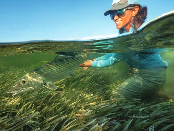 FIU researcher, Jennifer Rehage, in the water with a bonefish